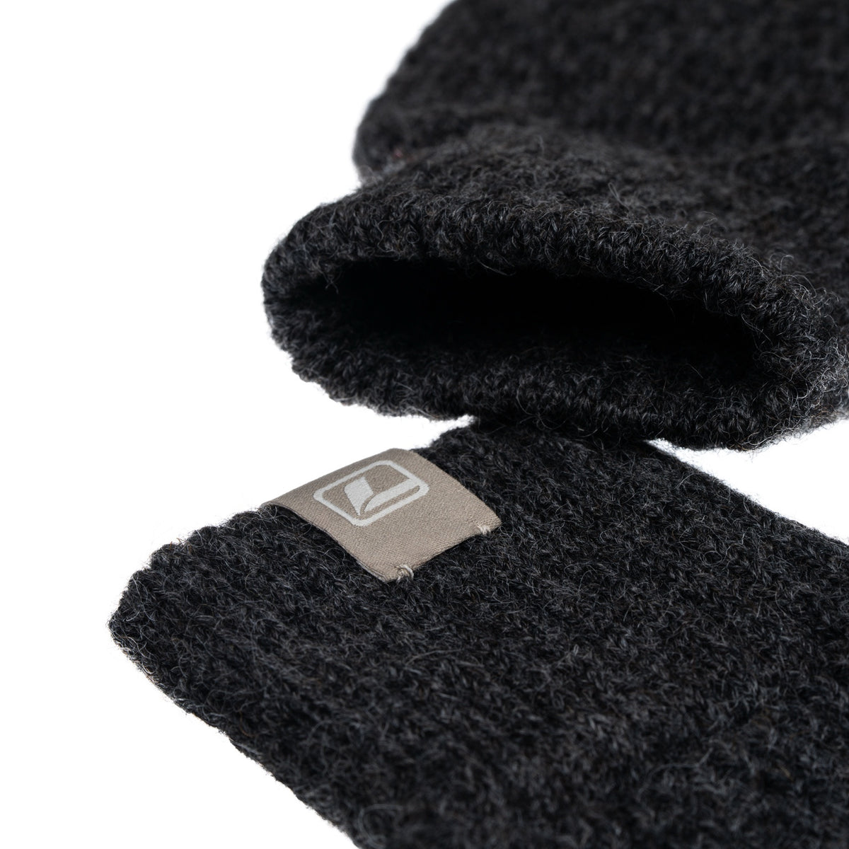 Close-up of knitted British wool and LOOP logo label on fingerless gloves