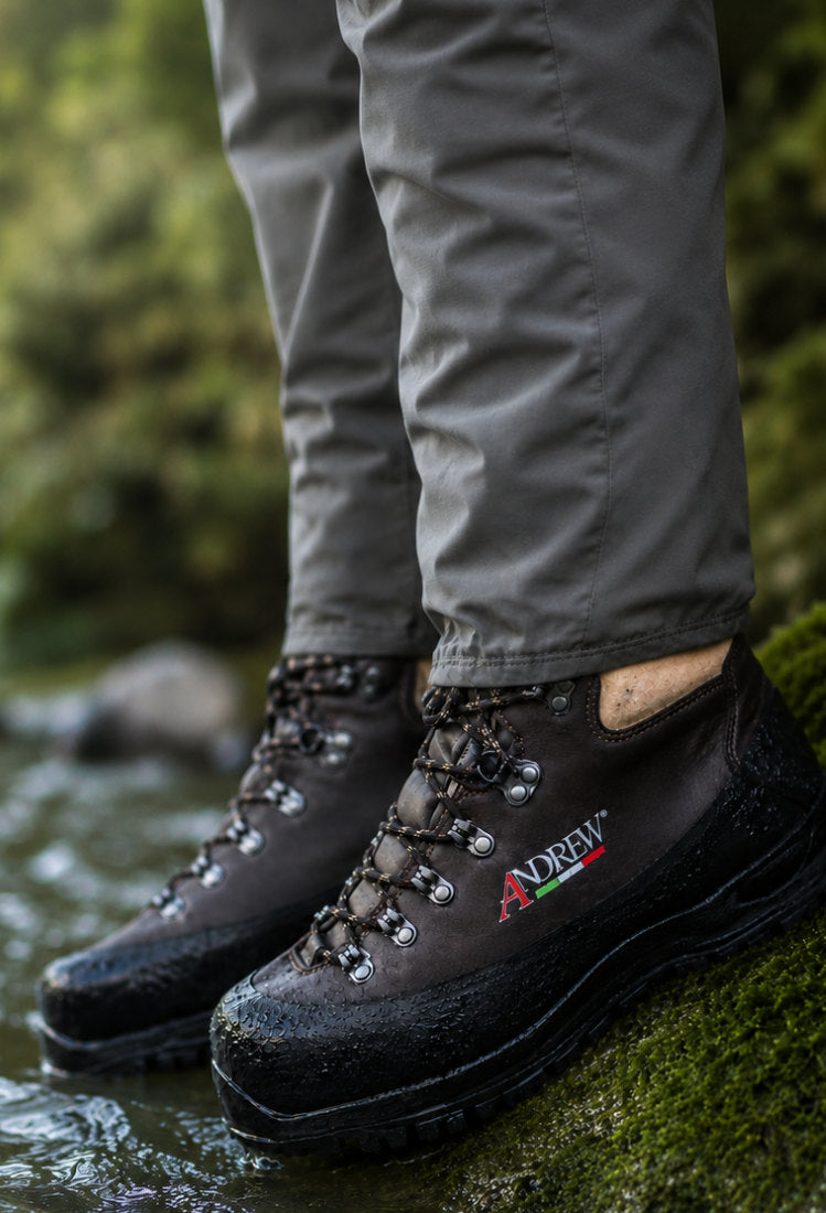 Andrew fly fishing boots on a rocky riverbank, designed for demanding wading conditions