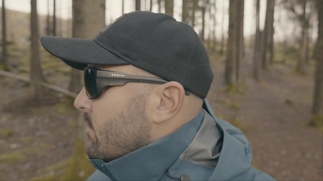 Leech X1 Water polarized fishing sunglasses worn by an angler in forest surroundings