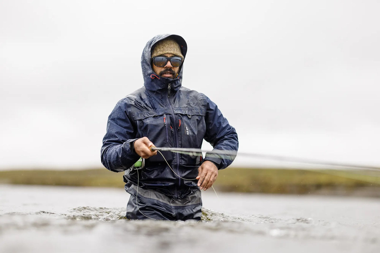 LOOP Dellik Wading Jacket worn while fly fishing in wet conditions