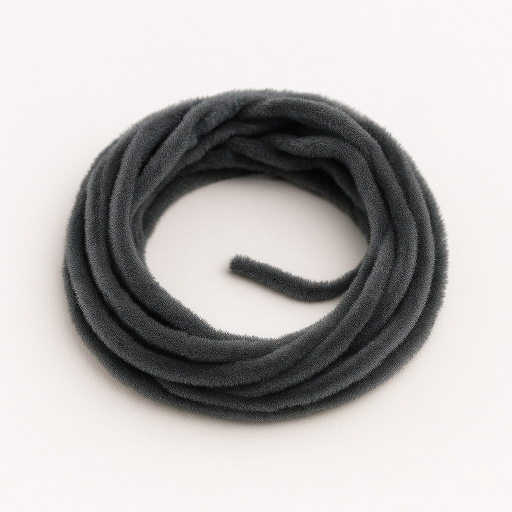 Black Soldarini Wormstasy Chenille fly-tying material, close-up pulsing fiber texture, studio lighting