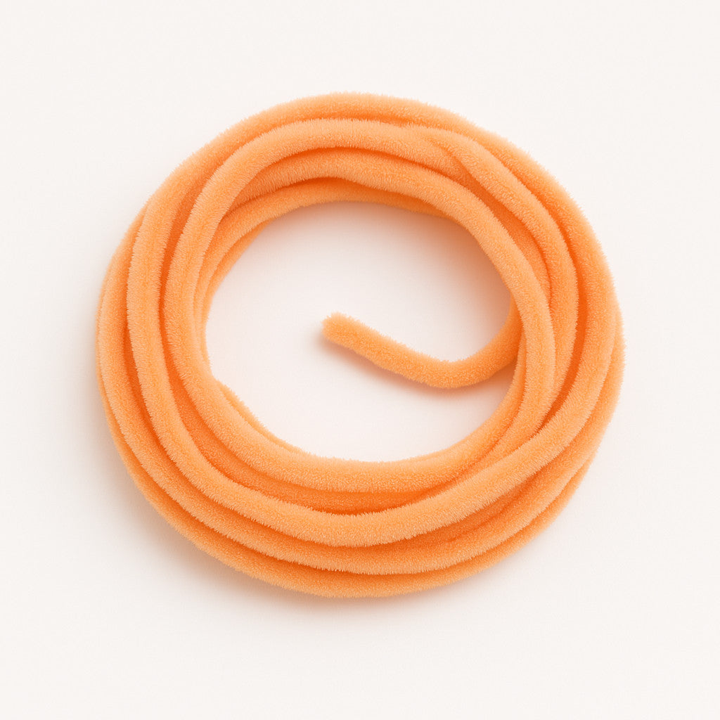 Peach Soldarini Wormstasy Chenille fly-tying material, close-up pulsing fiber texture, studio lighting